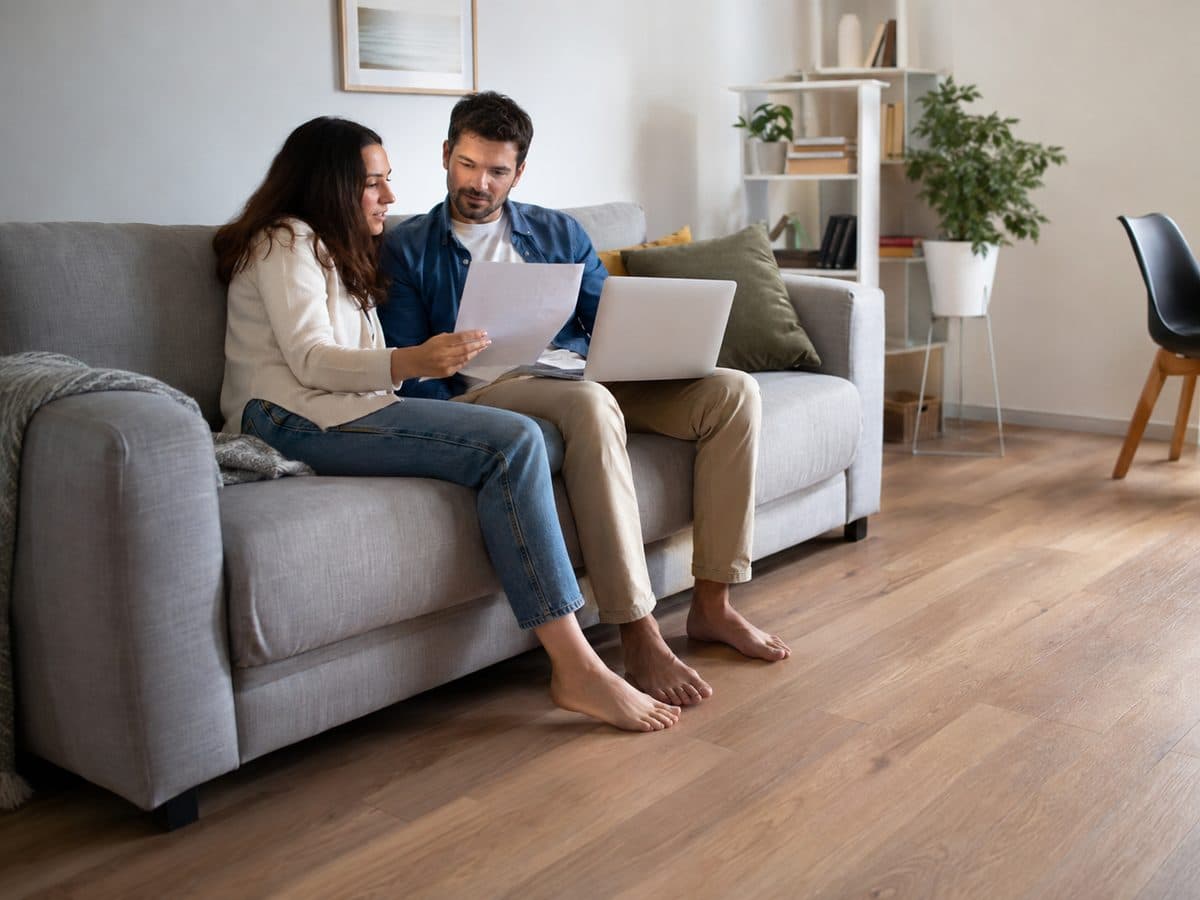 A couple relaxing on a couch in their living room