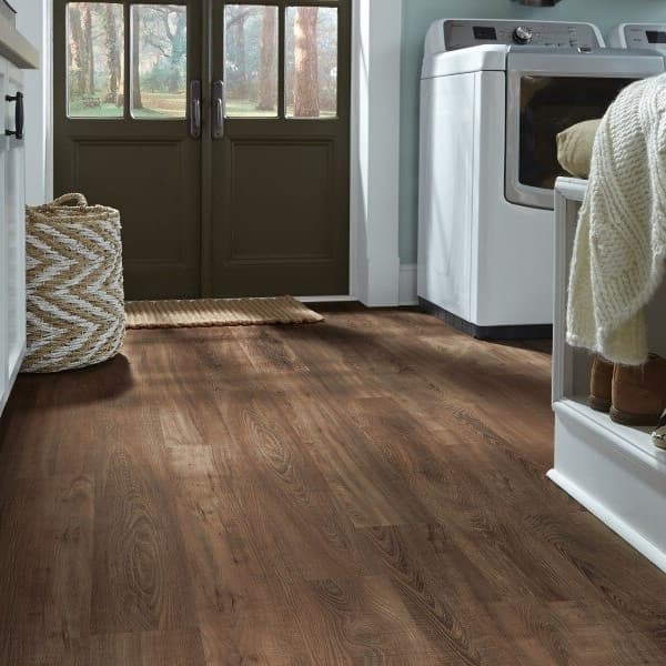 Laundry room with Mannington Adura 6" rigid waterproof plank flooring in Iron Hill Smoked Ash