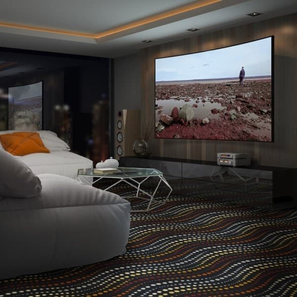 Living room with Joy Carpets Sidewinder Carpet in Sunset pattern, featuring wavy multicolored design