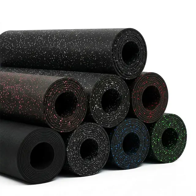 Stacked rubber flooring rolls in solid black and several colored-fleck finishes.