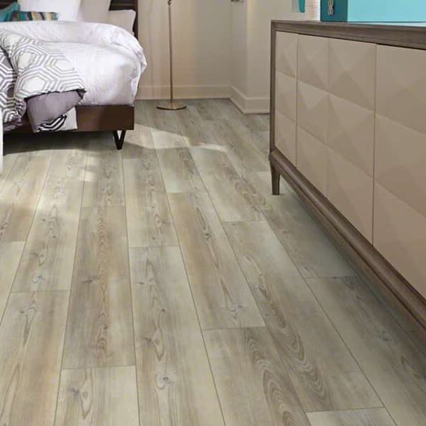 Shaw Paragon Plus 7" rigid core vinyl planks in Whitefill Oak — bedroom floor with light gray wood grain pattern