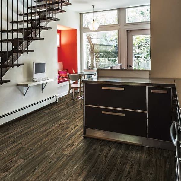 Modern kitchen with New Standard 2 rigid core vinyl planks in Bay of Plenty, dark wood grain flooring