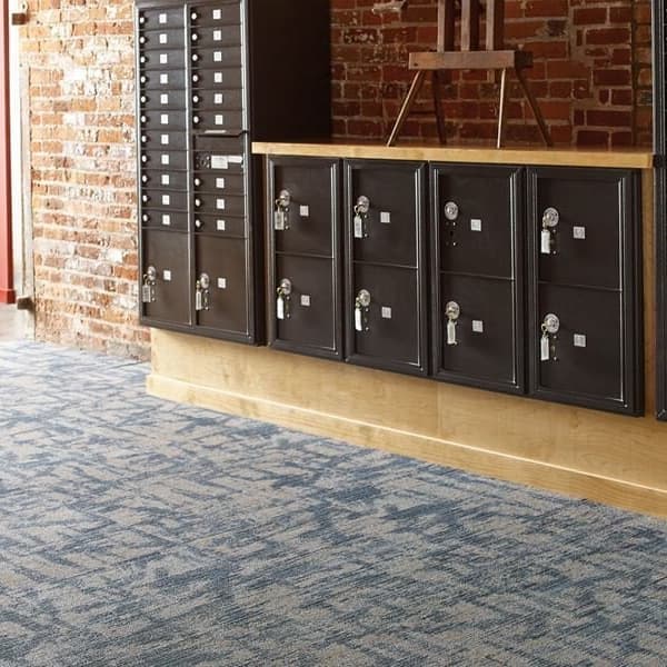 Shaw Wildstyle Carpet Tile, Code pattern — blue and gray abstract design in a hallway with mailboxes