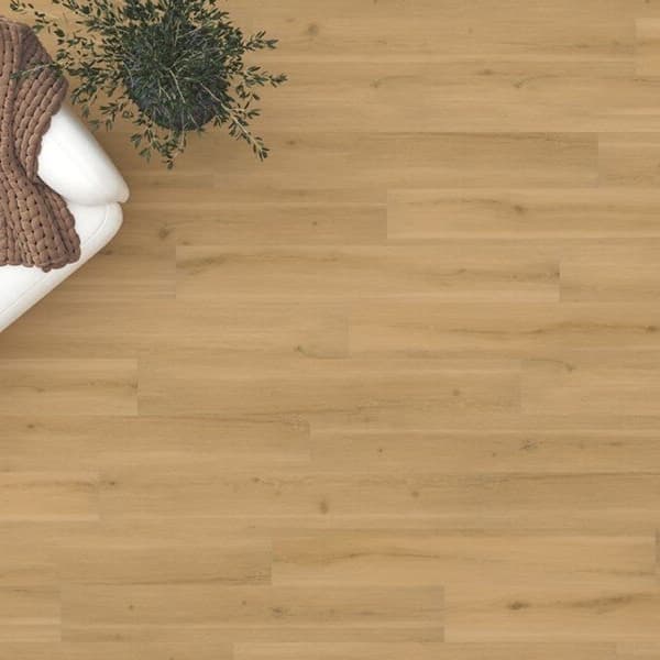 Adura Flex 7" vinyl planks, Aspen Drift — living room floor with white sofa and knit throw, light wood grain pattern
