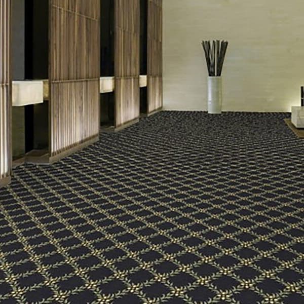 Shaw Cannonboro Carpet, Latticework pattern — dark blue carpet with gold geometric design in a hallway