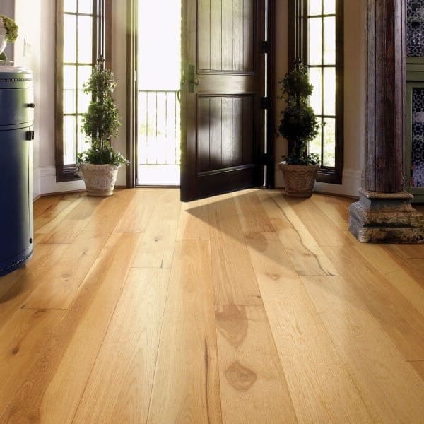 Shaw Castlewood Hickory Engineered Wood, Coat of Arms — light brown hardwood flooring in an entryway with a blue cabinet and