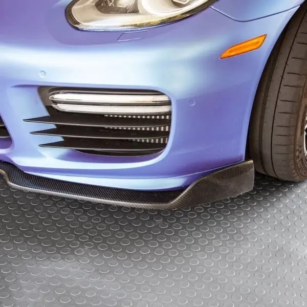 Car tire and body over Stainless Steel coin-pattern vinyl garage flooring.
