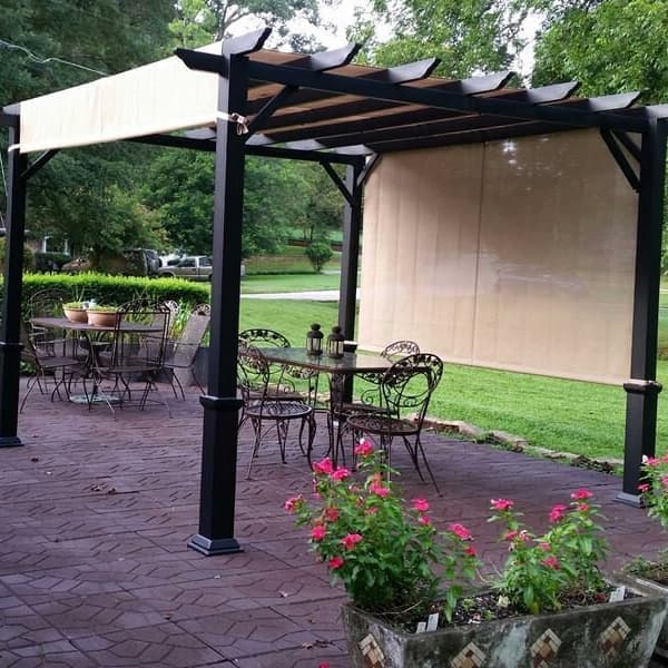 Flagstone Rubber Pavers in brown — outdoor patio with pergola, dining set, and flower planters