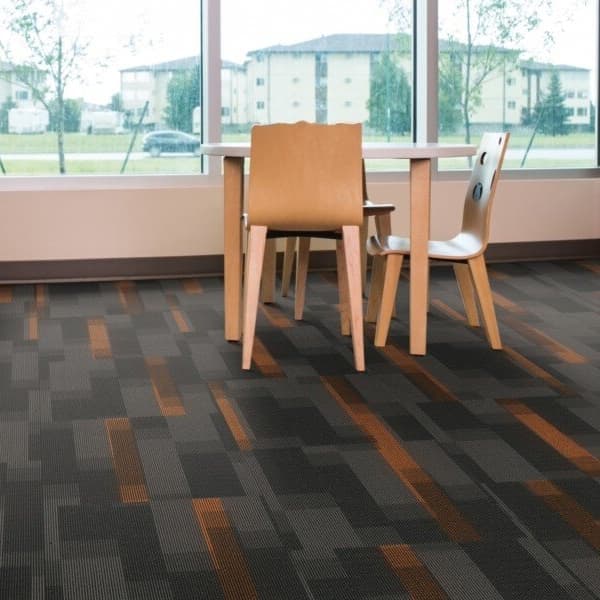 Pentz Magnify Carpet Tiles, Carob — library with dark gray and orange geometric patterned carpet tiles