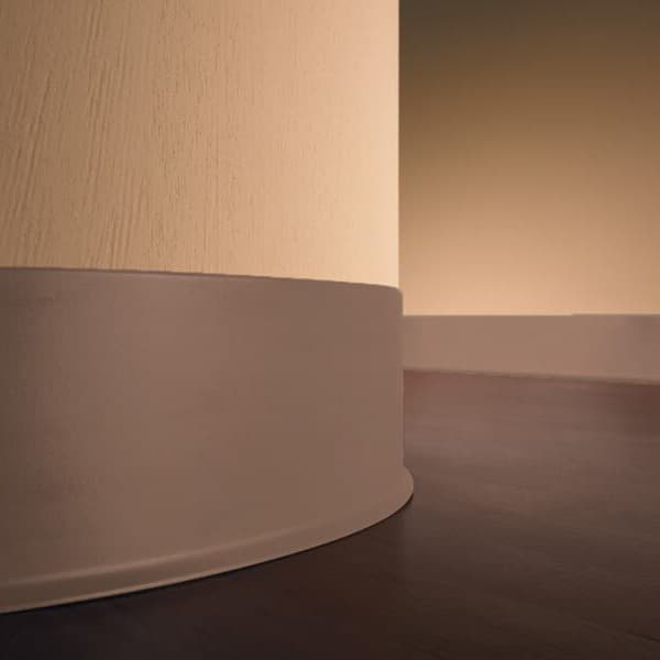 Eco Vinyl Wall Base — almond thermoplastic vinyl baseboard installed at wall-floor junction