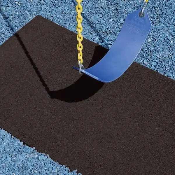 Playground swing mat, black — rectangular safety mat under a blue plastic swing seat with yellow chains, on blue rubber mulch