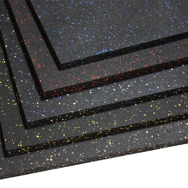 Rubber gym mats in a stack of five with colored speckled flecks in yellow, blue, red, and white.