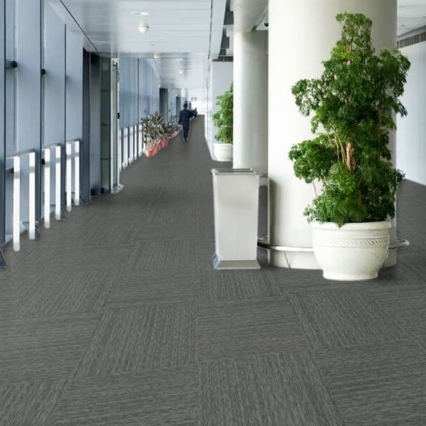 Office hallway with Pentz Visionary Carpet Tiles in Clever, dark gray textured pattern, installed in a staggered layout