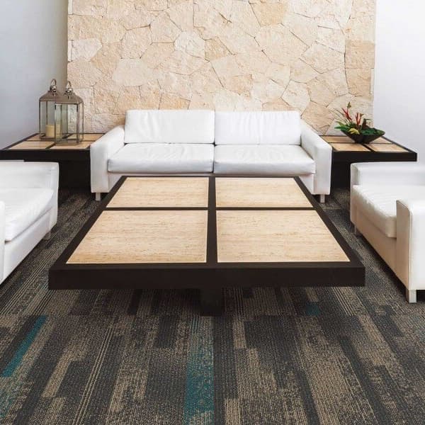 Mannington Elevation Carpet Tiles, Borough pattern — lounge area with white sofas and stone accent wall