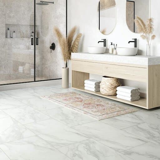 Luxury vinyl tile flooring in modern bathroom with a glass shower enclosure, and minimalist decor.