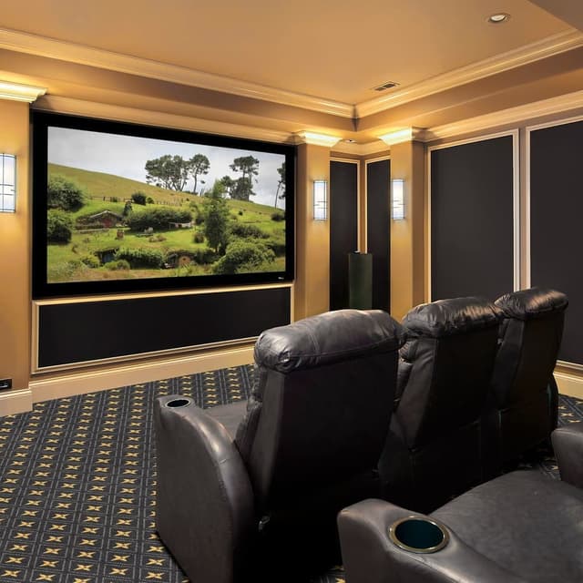 Home theater with Joy Carpets Star Trellis carpet in navy and gold pattern under leather recliners