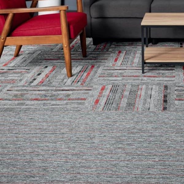 EF Contract Game On Carpet Tiles, One-Two Punch pattern — gray carpet tiles with red and black stripes under a red armchair
