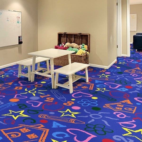 Joy Carpets Kid's Art Carpet, Rainbow — playroom with colorful patterned nylon carpet featuring letters, numbers, and shapes