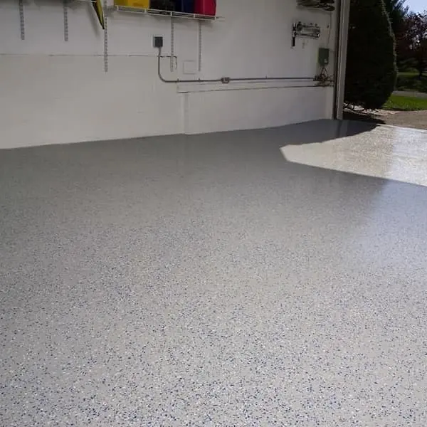 Epoxy garage coating in garage with a red car parked in the driveway.