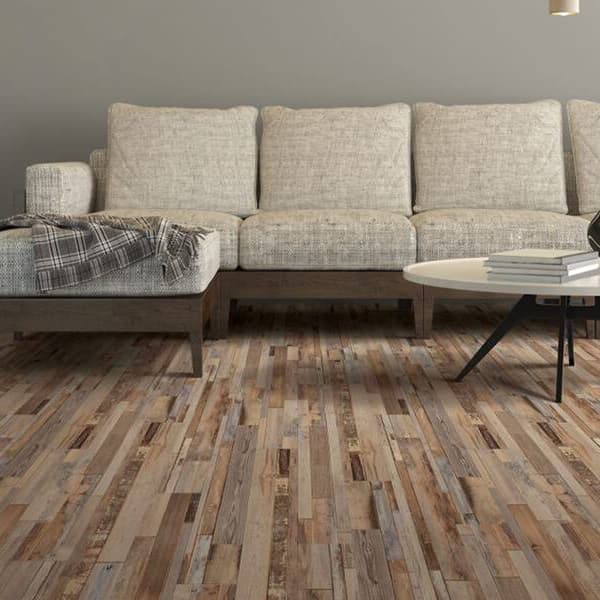 Waterproof vinyl planks in modern living room with light beige sectional sofa and a rounded coffee table.