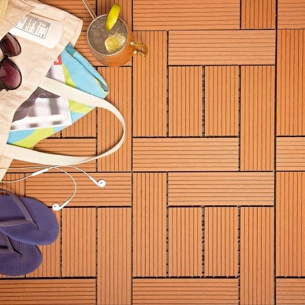 Helios Deck Tiles, red — interlocking composite decking surface with beach bag, flip-flops, and drink
