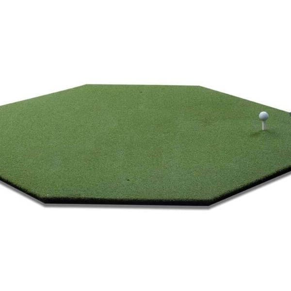 Golf mat with golf tee and practice balls on the side.