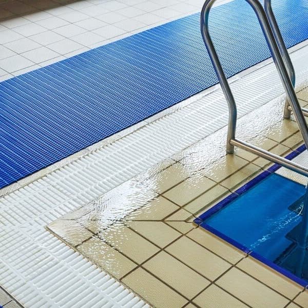 Blue and white Plastex Floorline Drainage Mats beside a swimming pool
