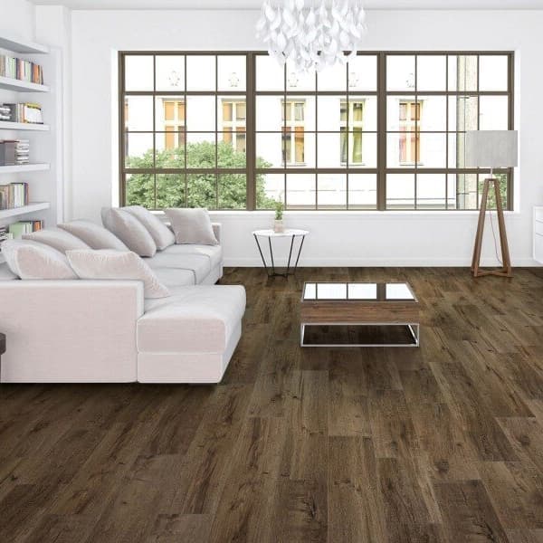 Waterproof vinyl flooring in modern living room with a white sectional couch, built-in bookshelves, and large windows.