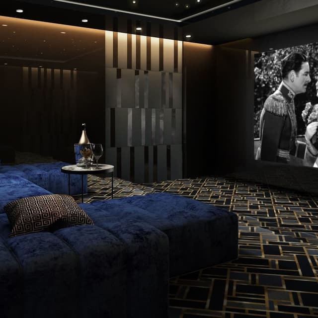 Home theater with Gatsby carpet in Azure, featuring a geometric black and gold pattern