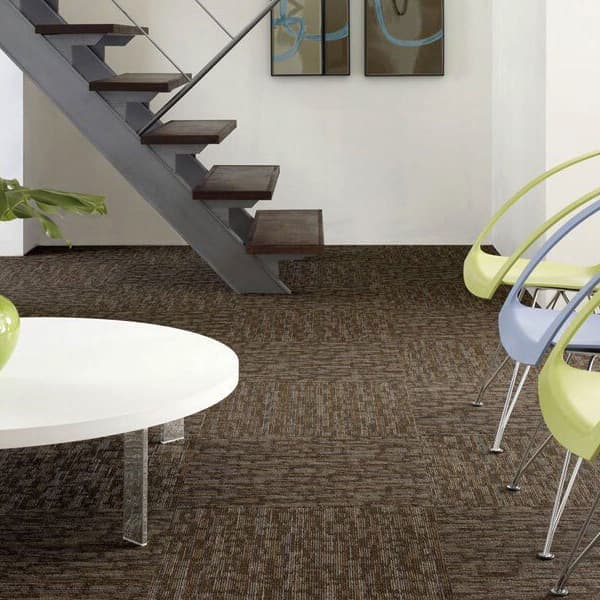 Shaw Hook Up Carpet Tile, Energize — modern living space with dark brown textured carpet tiles under a white coffee table and