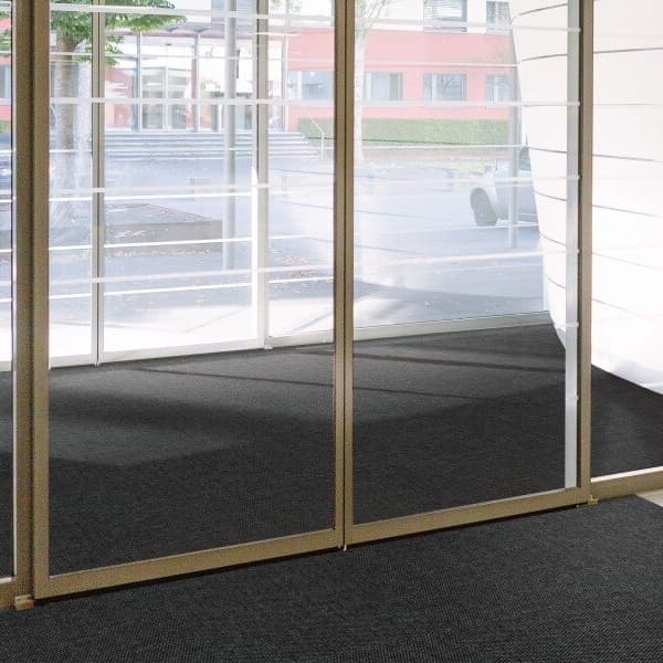 Imperial Heavy Hobnail Carpet Tile, Charcoal — installed in an office entryway with glass partitions and metal frames