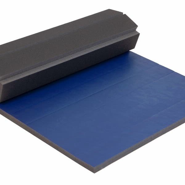 Home Wrestling Mat, Royal Blue — folded foam mat with blue top surface and gray edges, partially unrolled on white background