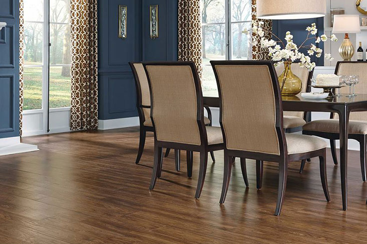 vinyl flooring in dining room with blue walls and dark furniture