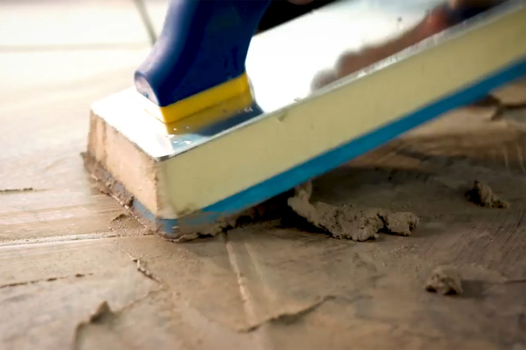 Applying grout to tile joints using a grout float