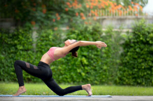 Women enjoying yoga outdoors. 