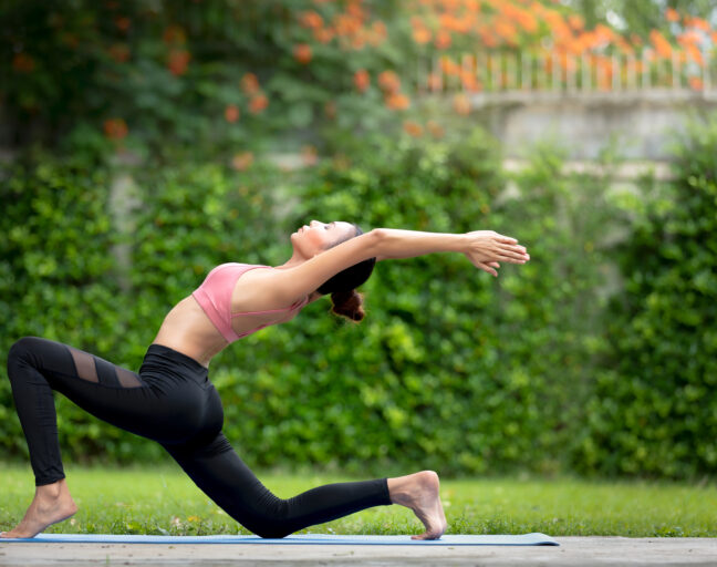 Women enjoying yoga outdoor.
