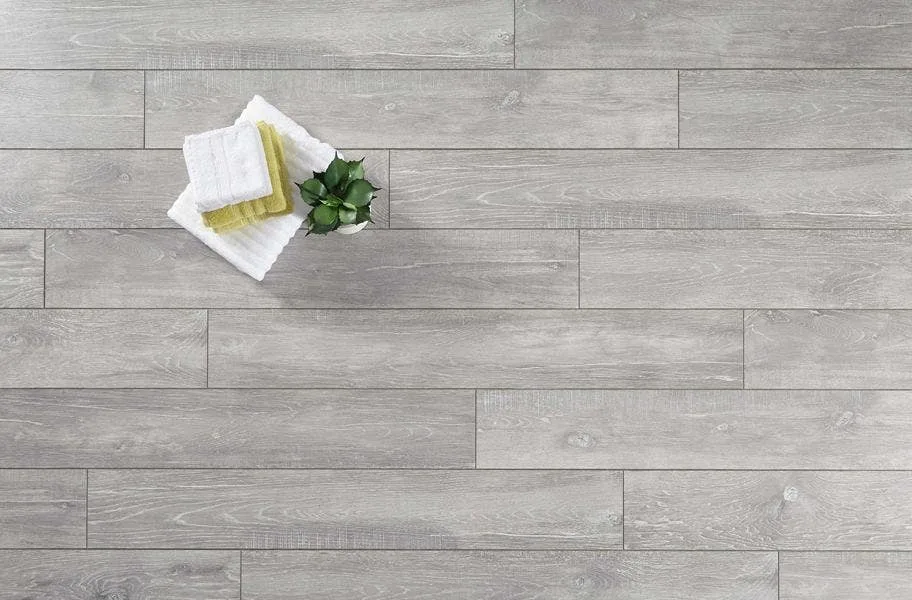 Shop Laminate Flooring gray laminate flooring flat lay with hand towels, washcloths and plant.