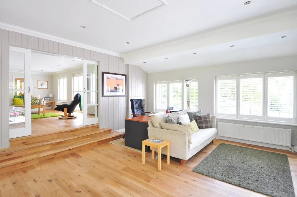 light hardwood floors in living room with white couch