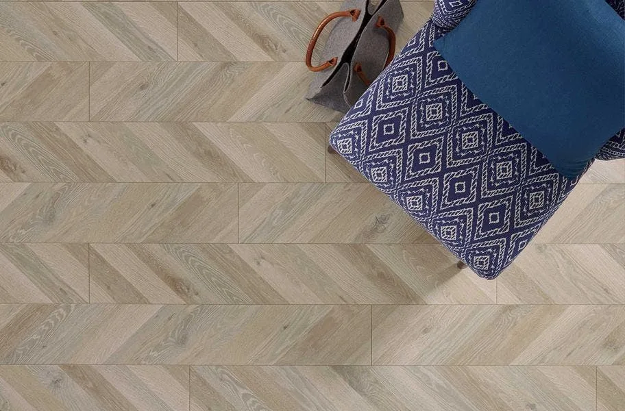 Shop Water Resistant Laminate above shot of waterproof laminate in a parquet style. Blue graphic chair and purse.