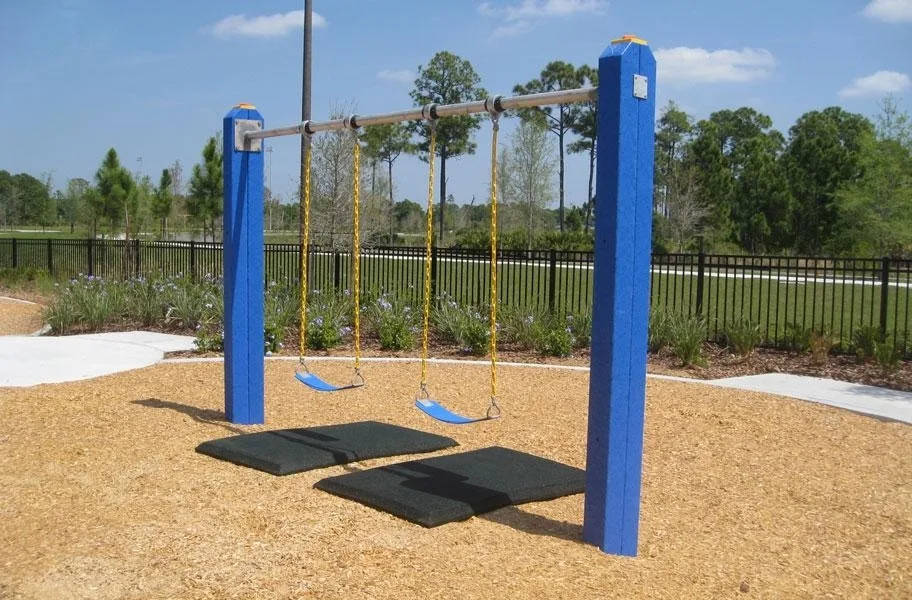 Swing set with two Safety Swing Mats underneath for added cushion and softer landing after children swing and play.