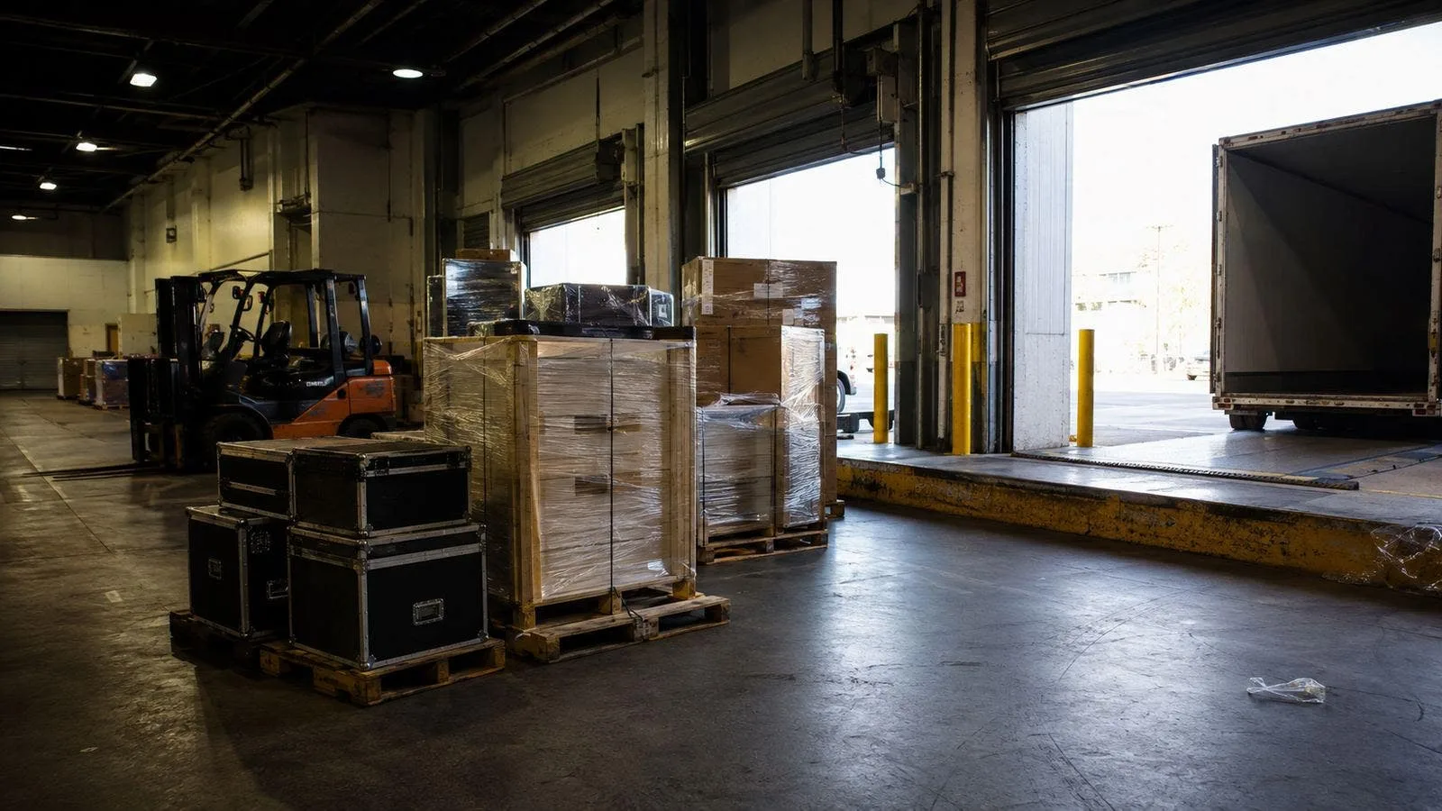 Convention center freight dock with palletized crates and a forklift during trade show move-in