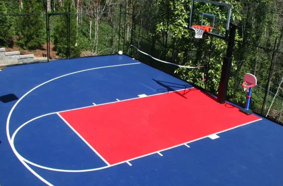 Interlocking outdoor basketball court tiles in vibrant blue and red, creating a low-maintenance and professional multi-sport playing surface with a basketball hoop.