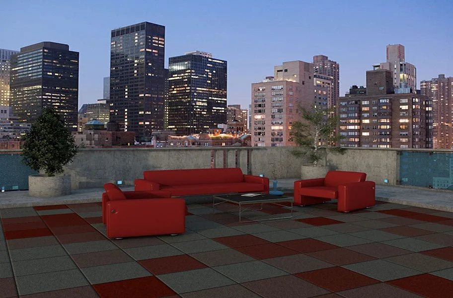 Red sofas on multicolor deck top roof tiles overlooking a city skyline