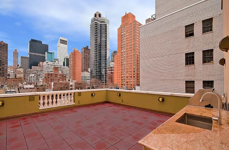 City rooftop terrace with red deck top roof tiles and an outdoor sink