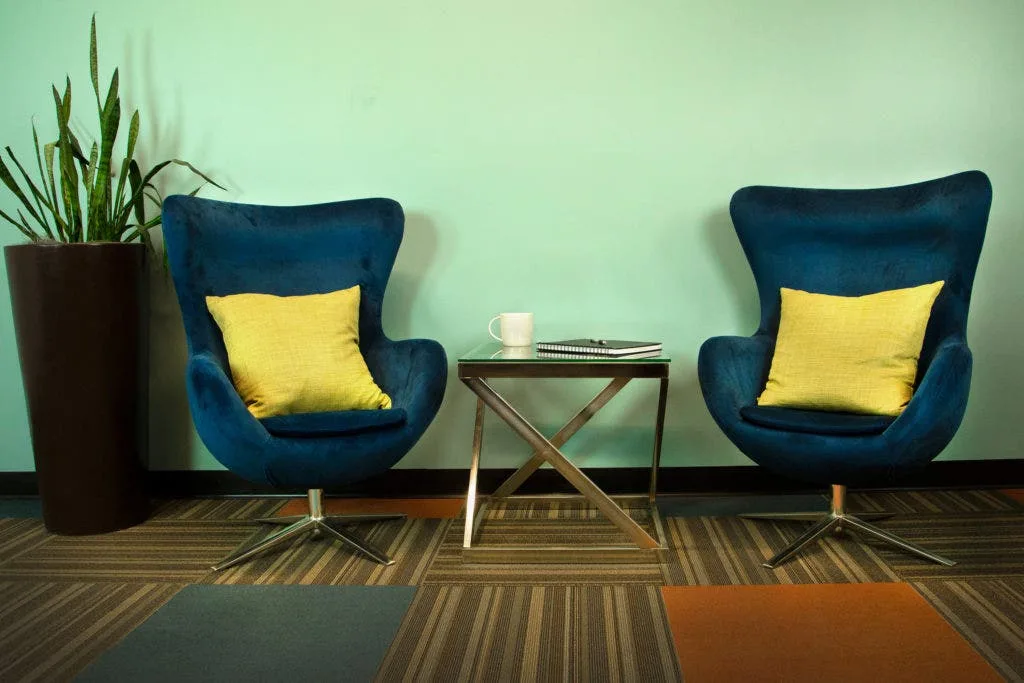 two chairs and table over low pile carpet