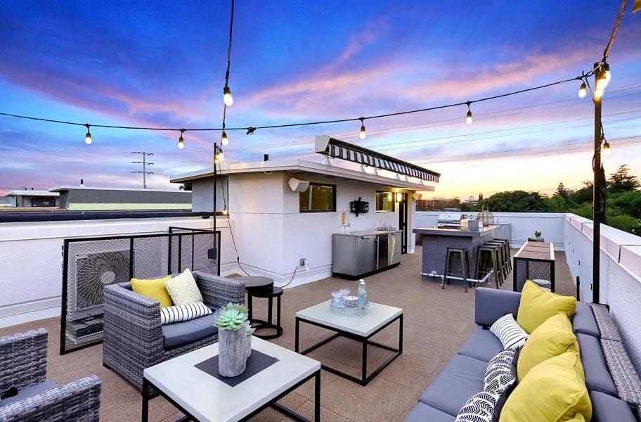 Rooftop deck with sectional seating on tan interlocking deck top roof tiles