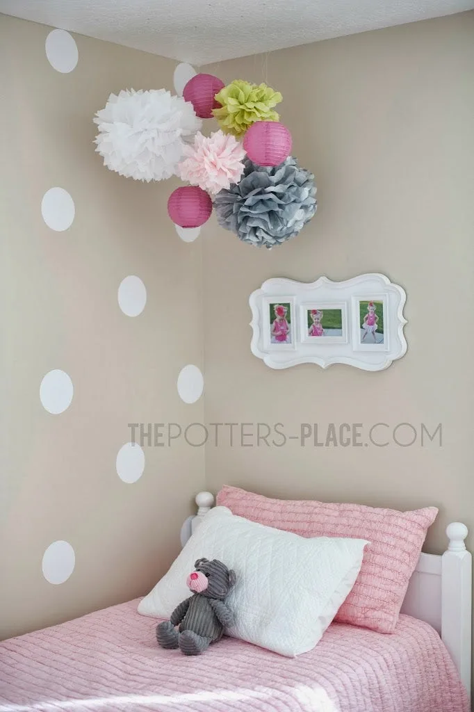Girls bedroom with white polka dot vinyl wall decals and paper lanterns