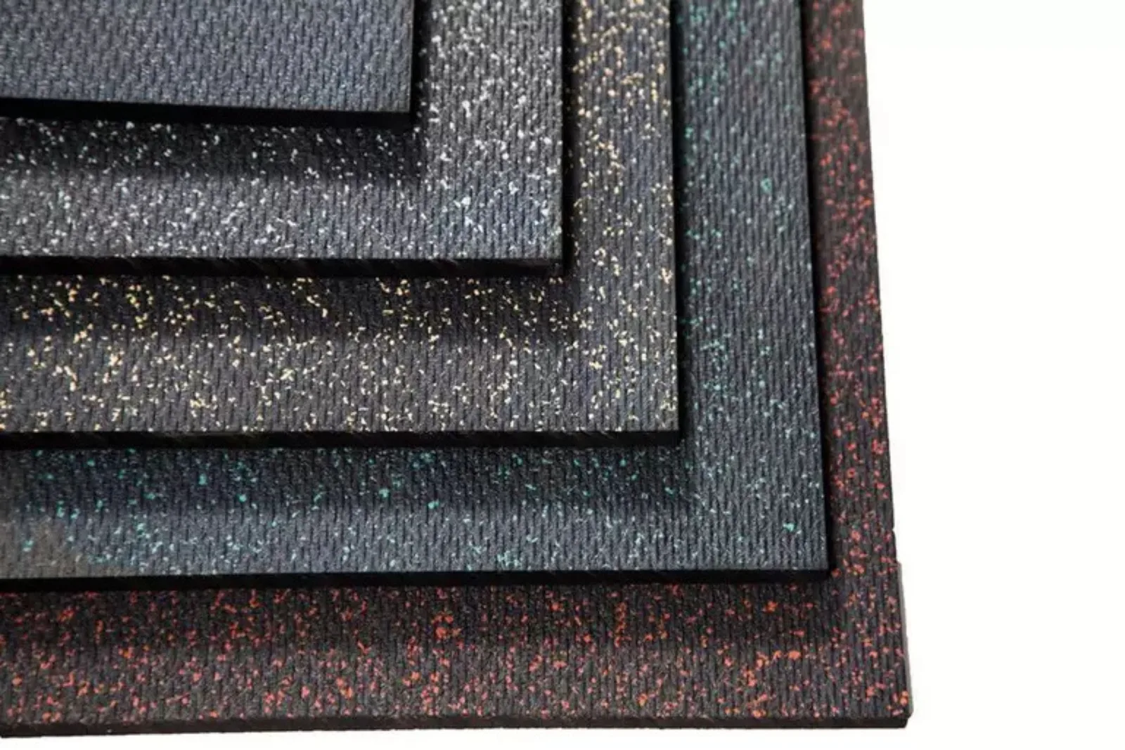 Stack of black rubber gym mats with colored flecks