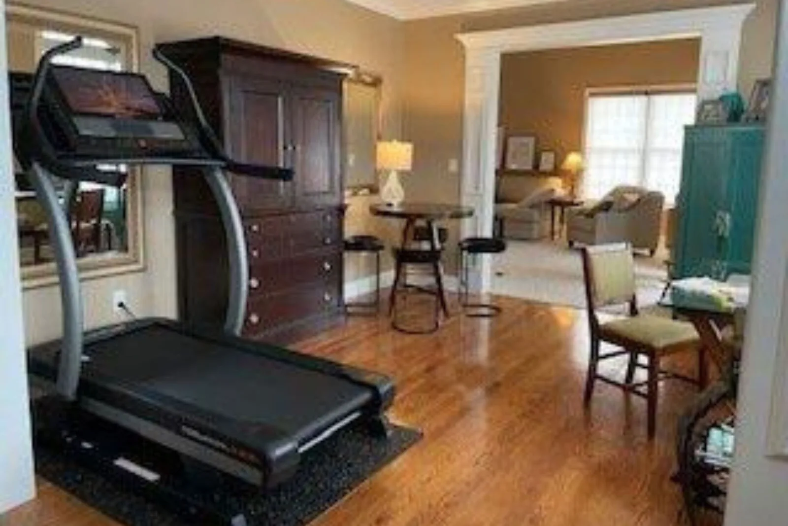 Treadmill on a 4 by 6 foot premium rubber mat over hardwood floors