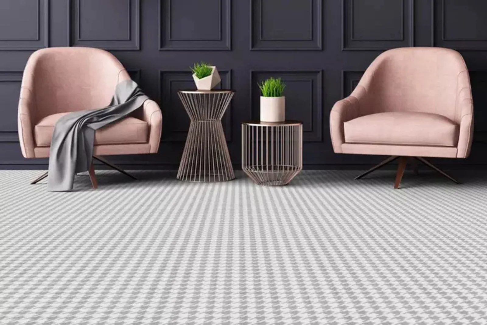 Gray houndstooth indoor carpet roll in a living room with two pink armchairs